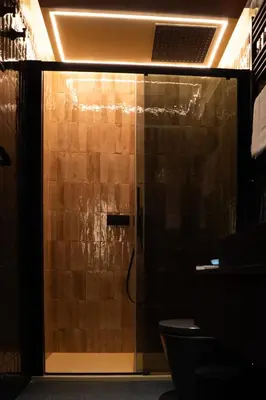 a shower with a glass door in a bathroom at Boada Riera - The RoomsbyReini in Terrassa