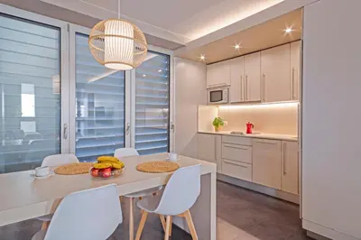 a bedroom with a large white bed with white pillows at BCN MONTJUÏC Apartments in Barcelona