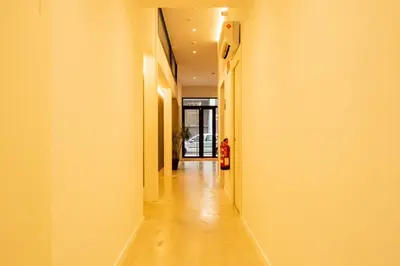 a hallway with a long corridor with yellow walls at GuestReady - ARIQUS Apartments in Barcelona