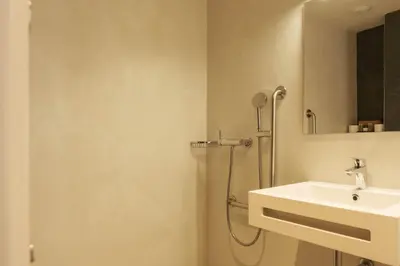 a bathroom with a shower and a sink at GuestReady - ARIQUS Apartments in Barcelona