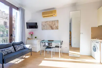 a living room with a couch and a table at Studio Premium en Sants a 15' Bcn Centro y Fira Bcn in Barcelona
