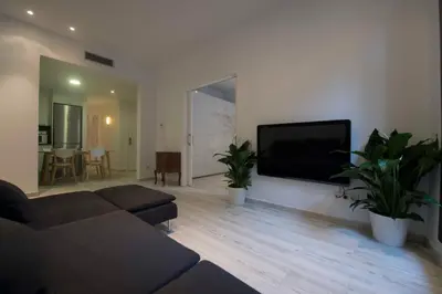 a living room with a couch and a flat screen tv at Roger De Lluria Design Apartment in Barcelona