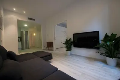 a living room with a couch and a flat screen tv at Roger De Lluria Design Apartment in Barcelona
