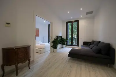 a living room with a couch and a table at Roger De Lluria Design Apartment in Barcelona