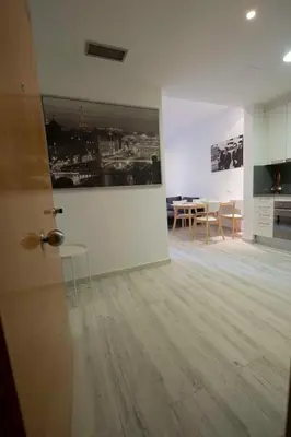 a living room with a table and a painting on the wall at Roger De Lluria Design Apartment in Barcelona