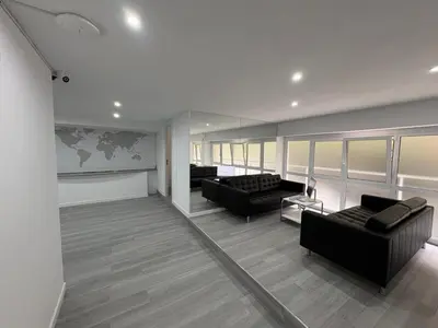 a living room with two couches and a map on the wall at Hostel Hock Residences in Hospitalet de Llobregat
