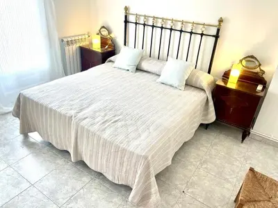 a bedroom with a large white bed with two pillows at Camins de Montserrat in El Bruc