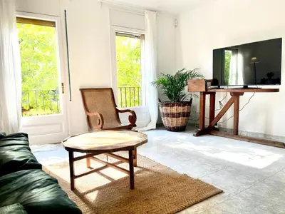 a living room with a couch and a chair at Camins de Montserrat in El Bruc