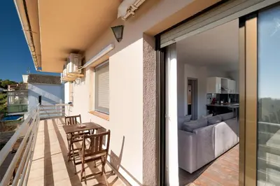 a balcony with a view of a living room at Mima House with Pool in Canyelles