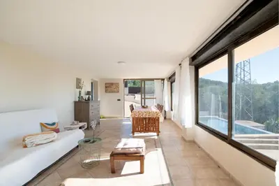 a living room with a couch and a table at Mima House with Pool in Canyelles