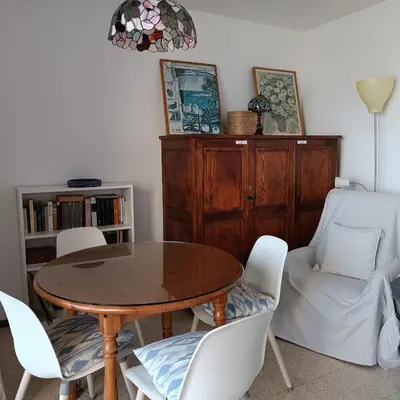 a dining room with a wooden table and chairs at Vivalidays Andrea - Pineda de Mar in Pineda de Mar