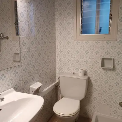 a bathroom with a white toilet and a sink at Vivalidays Andrea - Pineda de Mar in Pineda de Mar