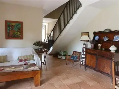 a living room with a couch and a staircase at Casa de pueblo con jardín in Premiá de Mar