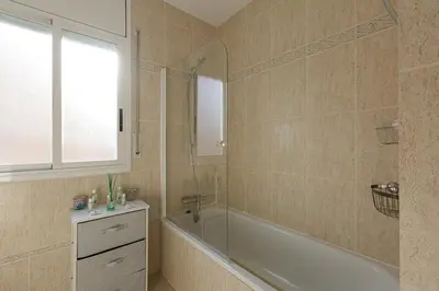 a bathroom with a bath tub and a sink at Fantástica casa en alquiler con piscina en Vilanova i la Geltrú in Vilanova i la Geltrú
