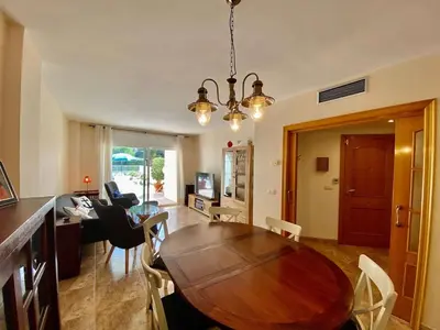 a dining room with a wooden table and chairs at Amazing apartment close to the beach Eli by Hl in Vilanova i la Geltrú