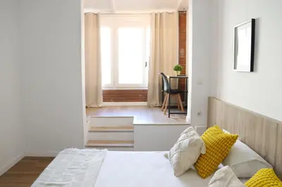 a bedroom with a bed with yellow pillows at Hamilton Suites in Barcelona