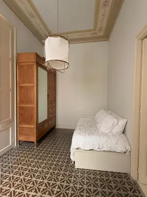 a bedroom with a bed and a dresser and a mirror at Ca La Manso in Sitges