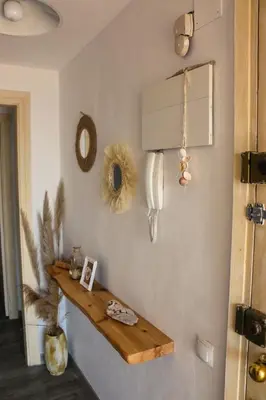a room with a wooden shelf on the wall at Mar de Flores in Vilassar de Mar