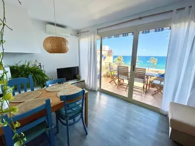 a dining room with a table and a view of the ocean at Mar de Flores in Vilassar de Mar