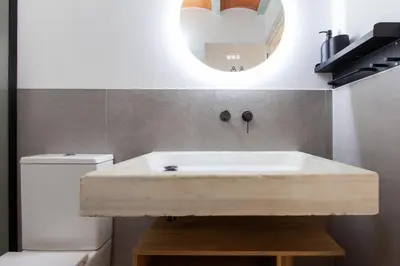 a bathroom with a white sink and a mirror at Aldana accommodation in the middle of nature in Molins de Rei