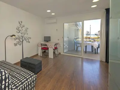 a living room with a couch and a table at Mery Castelldefels Beach in Castelldefels