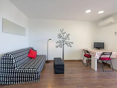 a living room with a couch and a table at Mery Castelldefels Beach in Castelldefels