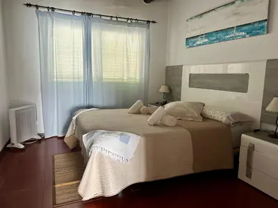 a bedroom with a bed and a window at Apartaments Mare Nostrum in Sitges