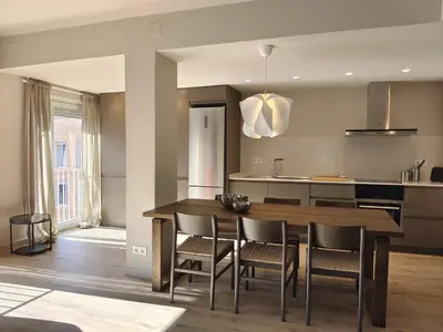 a kitchen and dining room with a table and chairs at Exclusive Beach District Flat - Fully Renovated in Barcelona