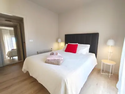 a bedroom with a large bed with two stuffed animals on it at Exclusive Beach District Flat - Fully Renovated in Barcelona