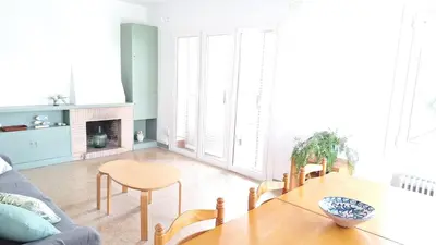 a living room with a table and a couch at Cozy apartment next to the beach in Sitges