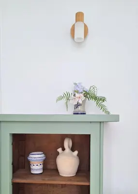 a green table with vases and a plant on it at Cozy apartment next to the beach in Sitges