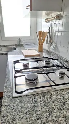 a stove top oven sitting on top of a kitchen counter at Cozy apartment next to the beach in Sitges