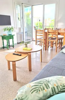 a living room with a coffee table and chairs at Cozy apartment next to the beach in Sitges