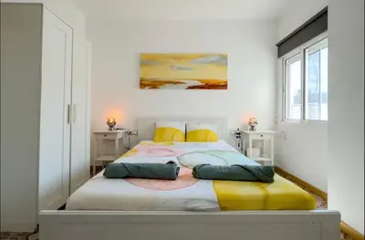 a bedroom with a large bed with yellow pillows at Apartamento en Barcelona Pau sans in Hospitalet de Llobregat