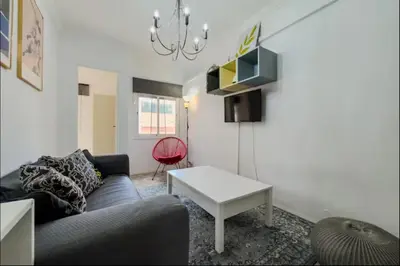 a living room with a couch and a table at Apartamento en Barcelona Pau sans in Hospitalet de Llobregat