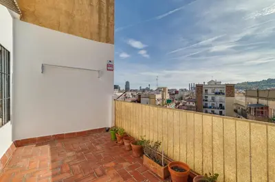 a balcony with potted plants on a building at Guest Ready‑Bright & Stylish Flat with 3 Terraces in Barcelona