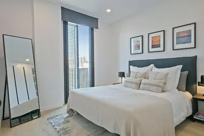 a bedroom with a large bed and a large window at 1 Bedroom Cozy Aparment Joan Austria in Barcelona