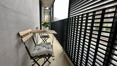 a small balcony with a table and a chair at 1 Bedroom Cozy Aparment Joan Austria in Barcelona