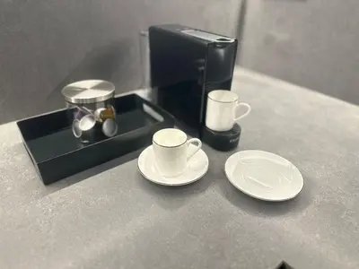 a coffee maker with two cups and plates on a counter at 1 Bedroom Cozy Aparment Joan Austria in Barcelona