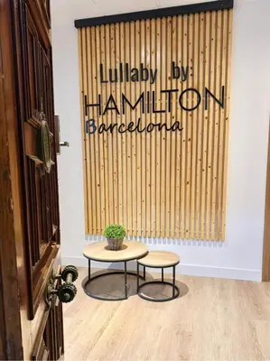 a patio with chairs and a table and plants at lullaby by hamilton in Barcelona