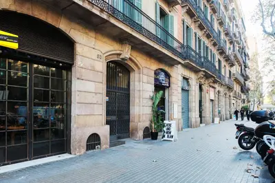a building with a motorcycle parked next to a street at Brummell Apartments Eixample Derecha/Ballroom in Barcelona