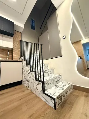 a staircase in a house with a stone wall at Beautiful duplex apartment in center Barcelona in Barcelona
