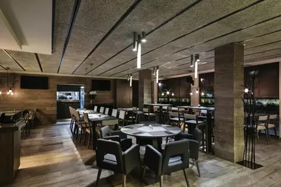 a restaurant with tables and chairs and a bar at Upper Diagonal in Barcelona