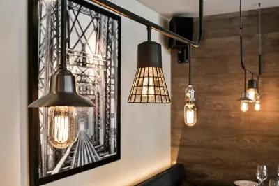 a room with three lights and a picture on the wall at Upper Diagonal in Barcelona