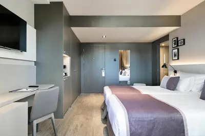 a hotel room with a bed and a desk at Upper Diagonal in Barcelona