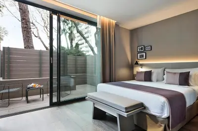 a bedroom with a large bed and a balcony at Upper Diagonal in Barcelona