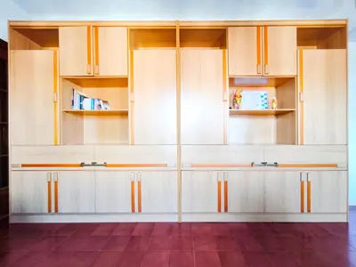 a kitchen with white cabinets and a red floor at Apartamento Canet de Mar Playa, Costa de Barcelona in Canet de Mar