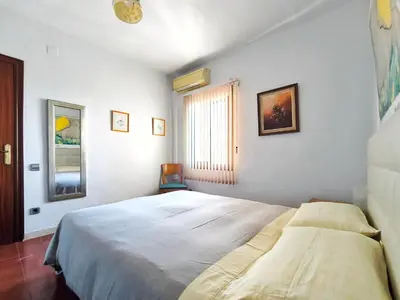 a bedroom with a large bed and a window at Apartamento Canet de Mar Playa, Costa de Barcelona in Canet de Mar
