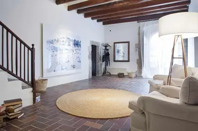 a bedroom with a bed and a desk and a table at Ca l'Andreu Ecoturisme in Tiana