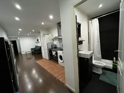 a bathroom with a sink and a washing machine at Private Room Barcelona center in Barcelona